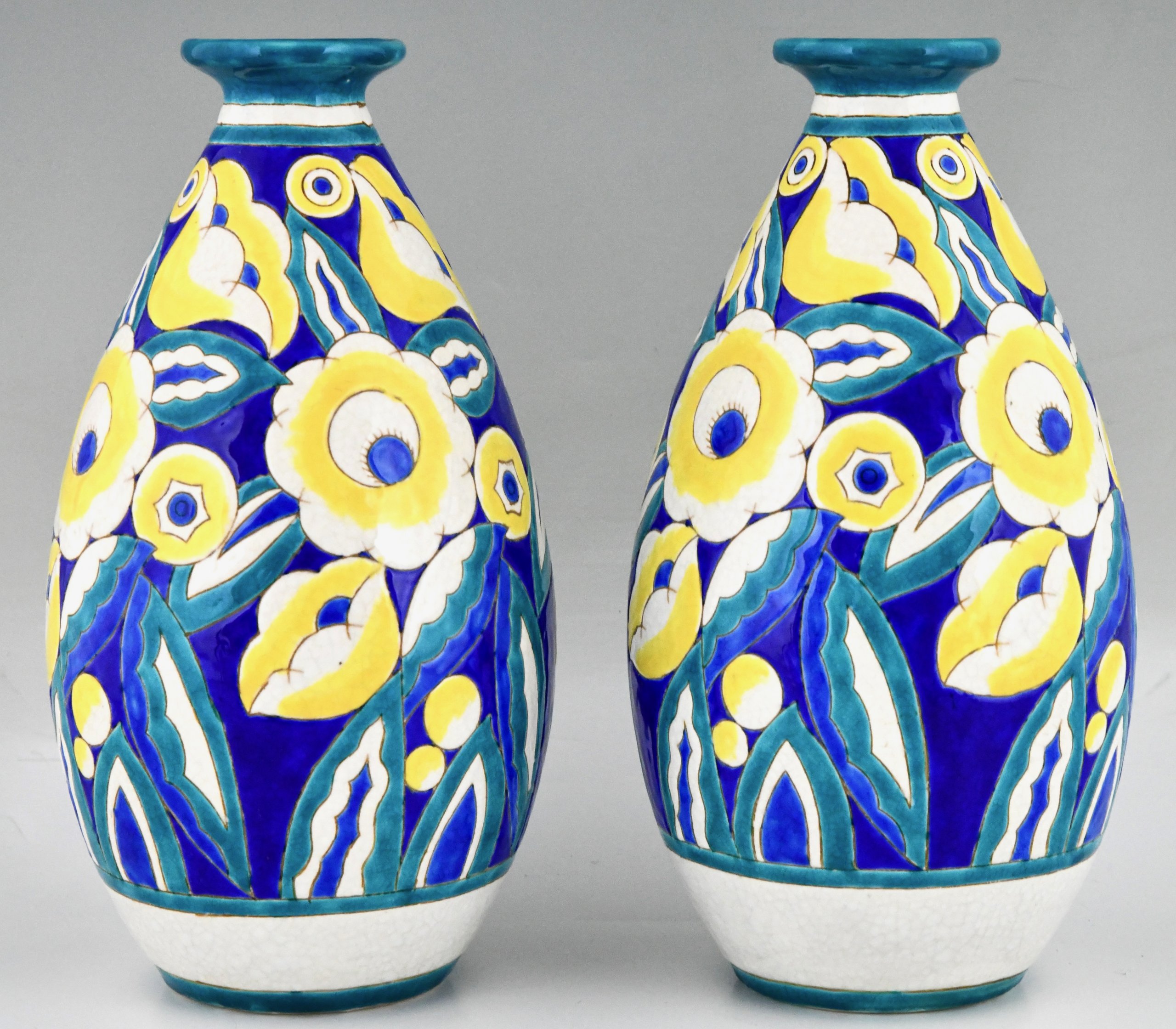 Pair of Art Deco ceramic vases with flowers.