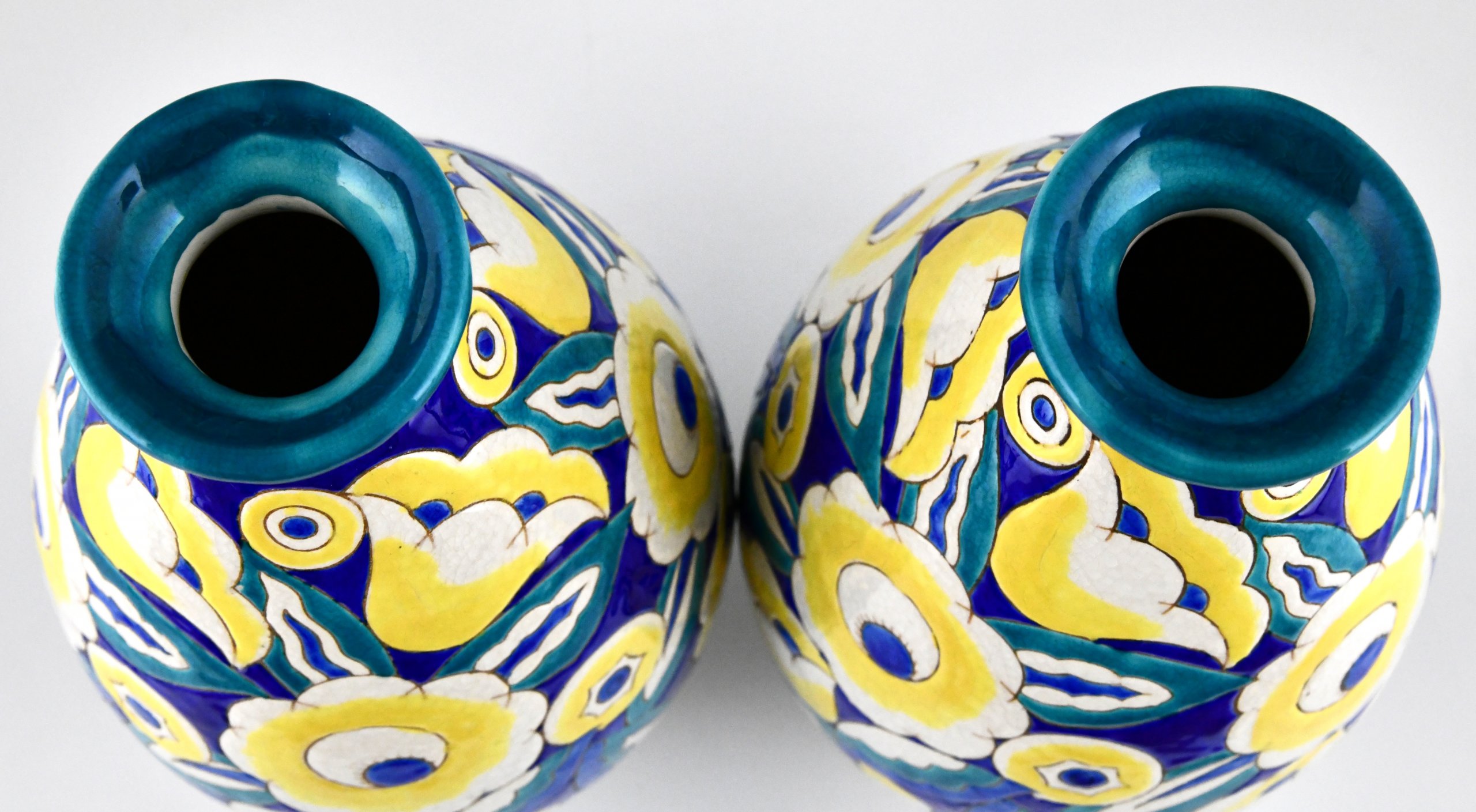 Pair of Art Deco ceramic vases with flowers.