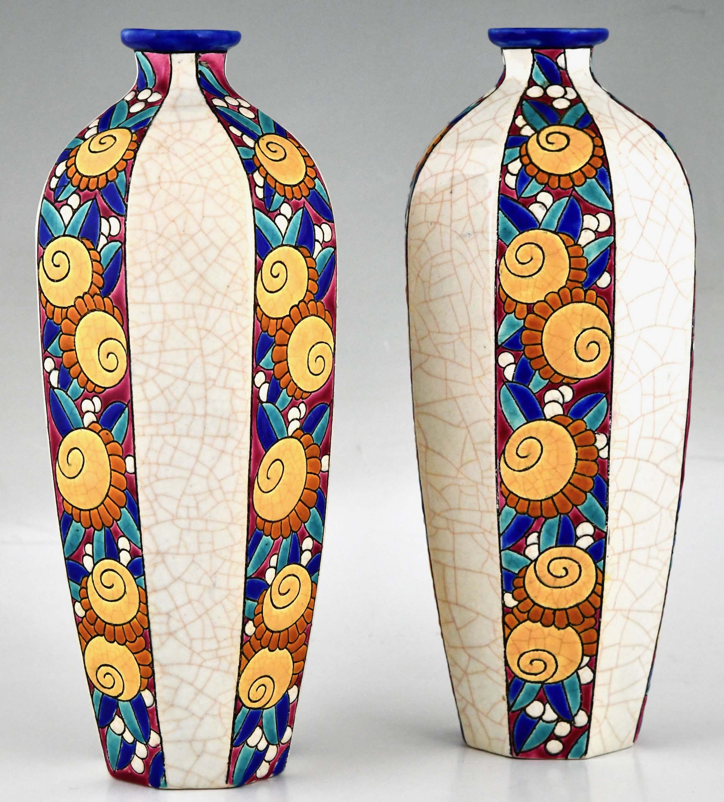 Pair of Art Deco ceramic vases with stylized flowers.