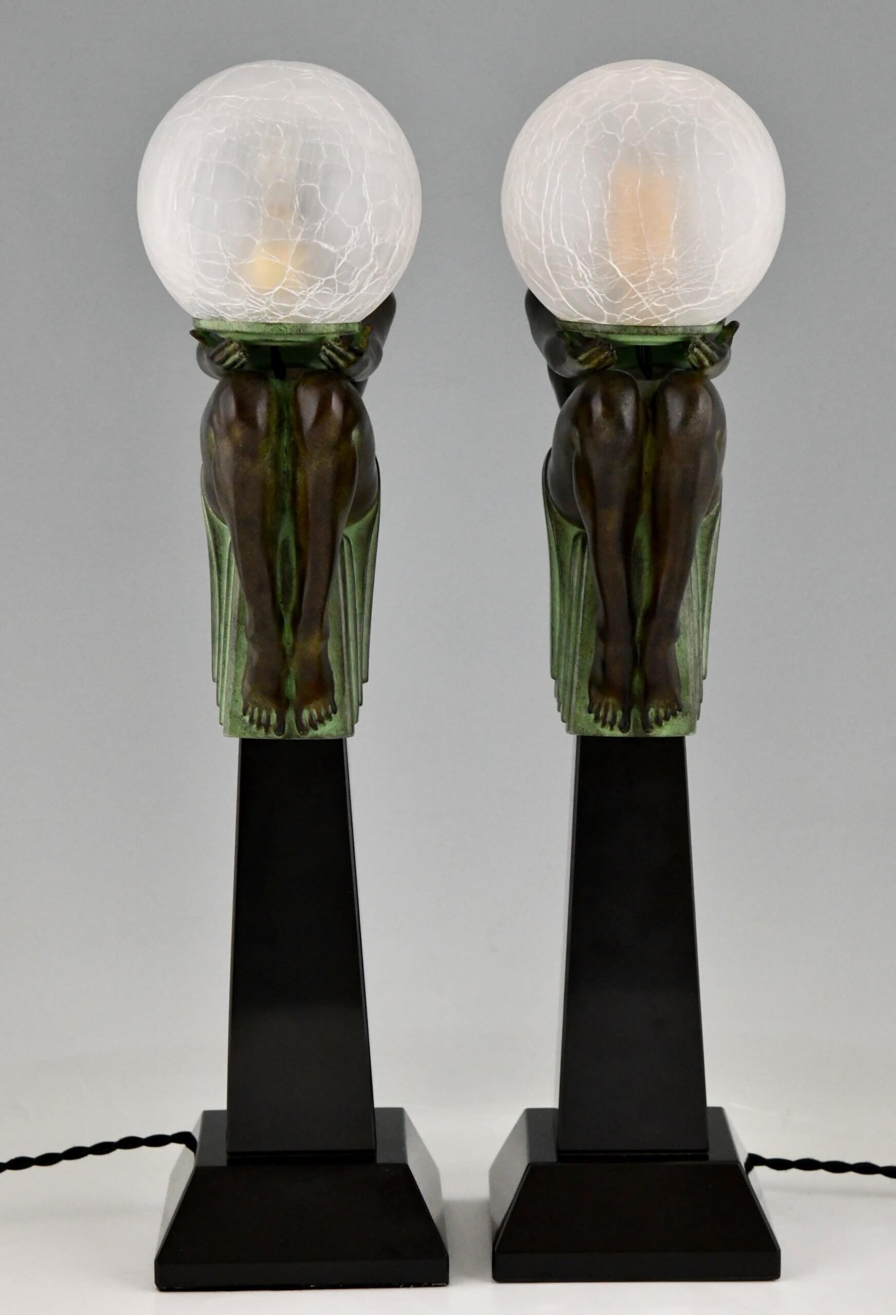Pair of Art Deco style lamps nude holding a globe ENIGME