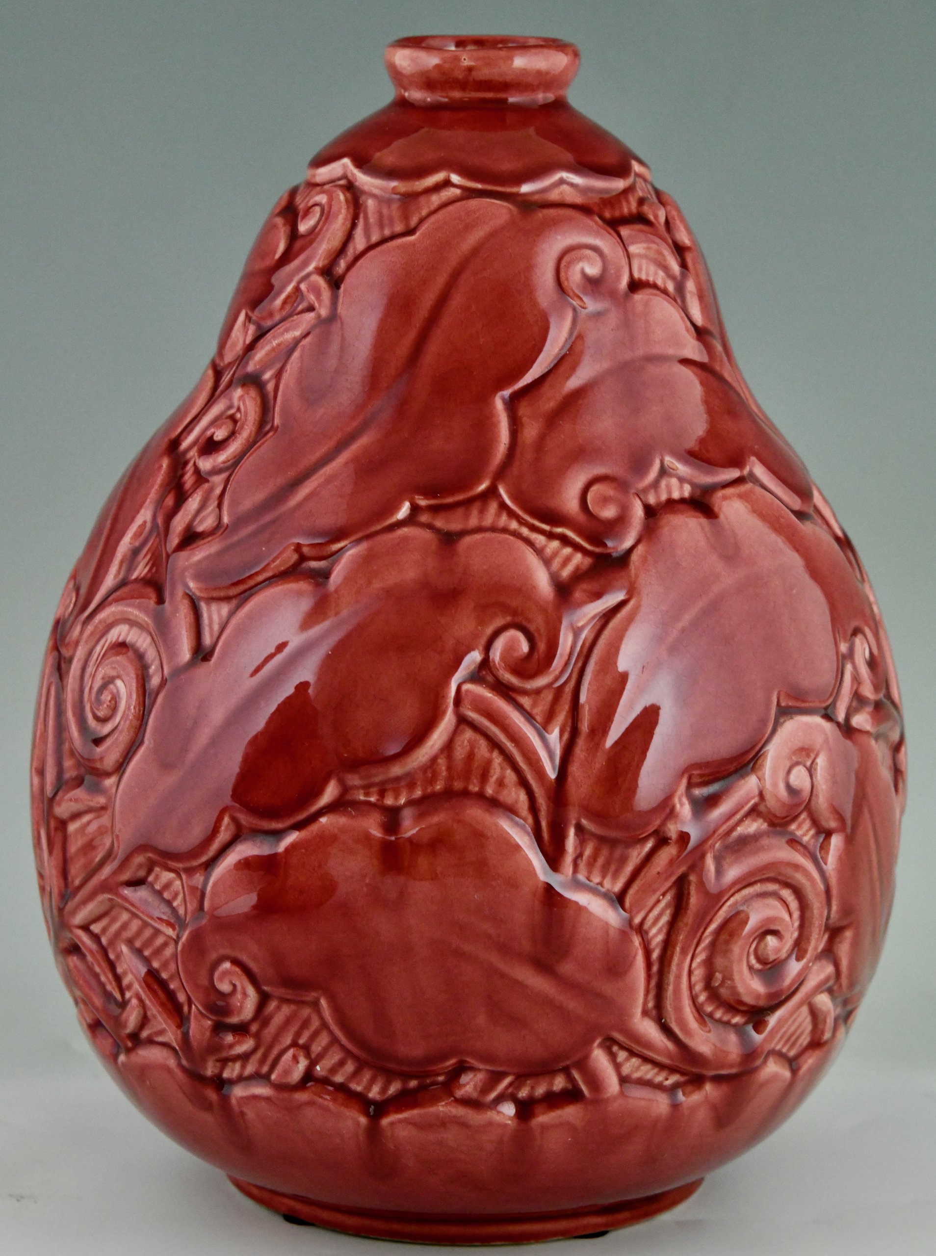Art Deco red ceramic vases with leaves.